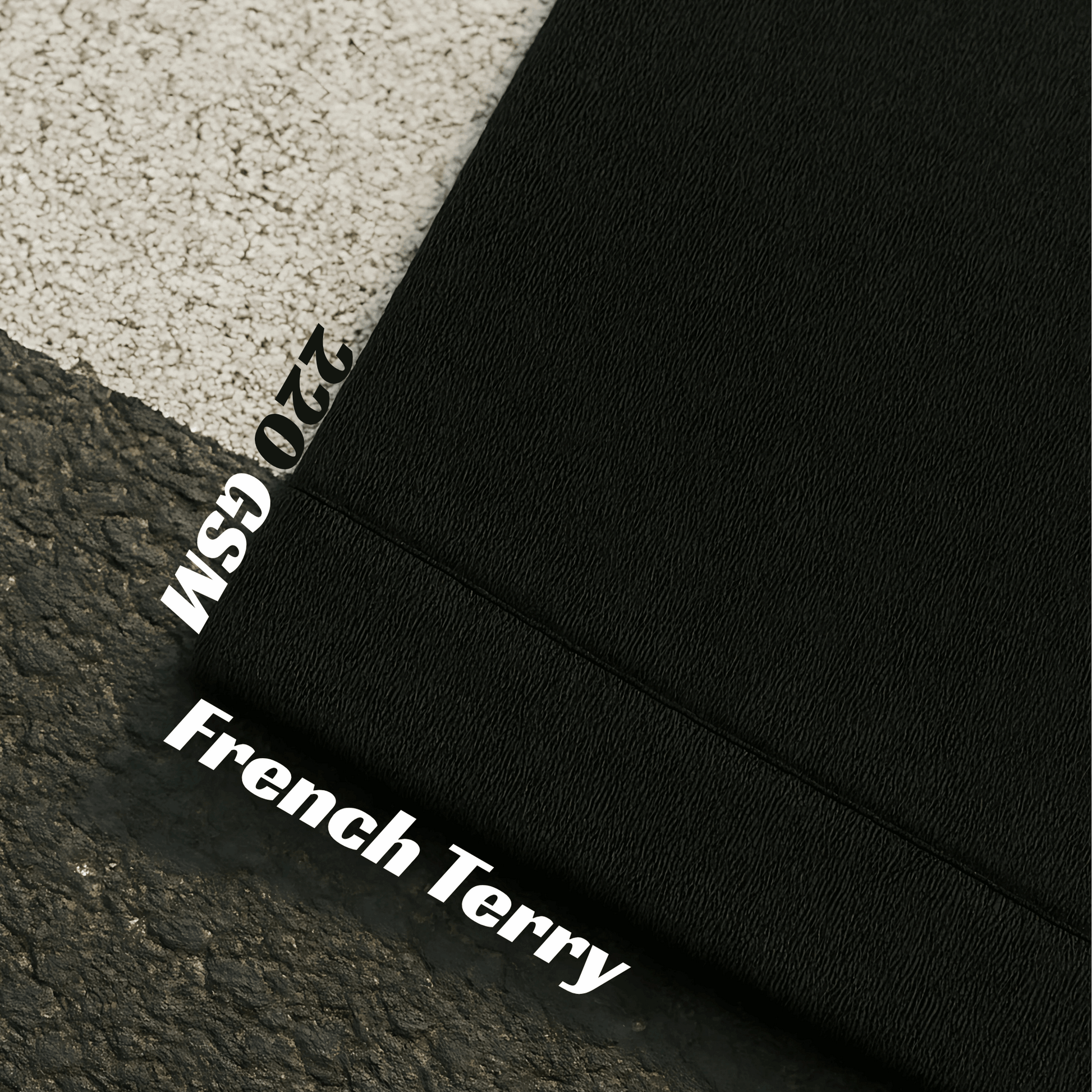 Black fabric with 'French Terry' and '220 GSM' text on a textured surface.