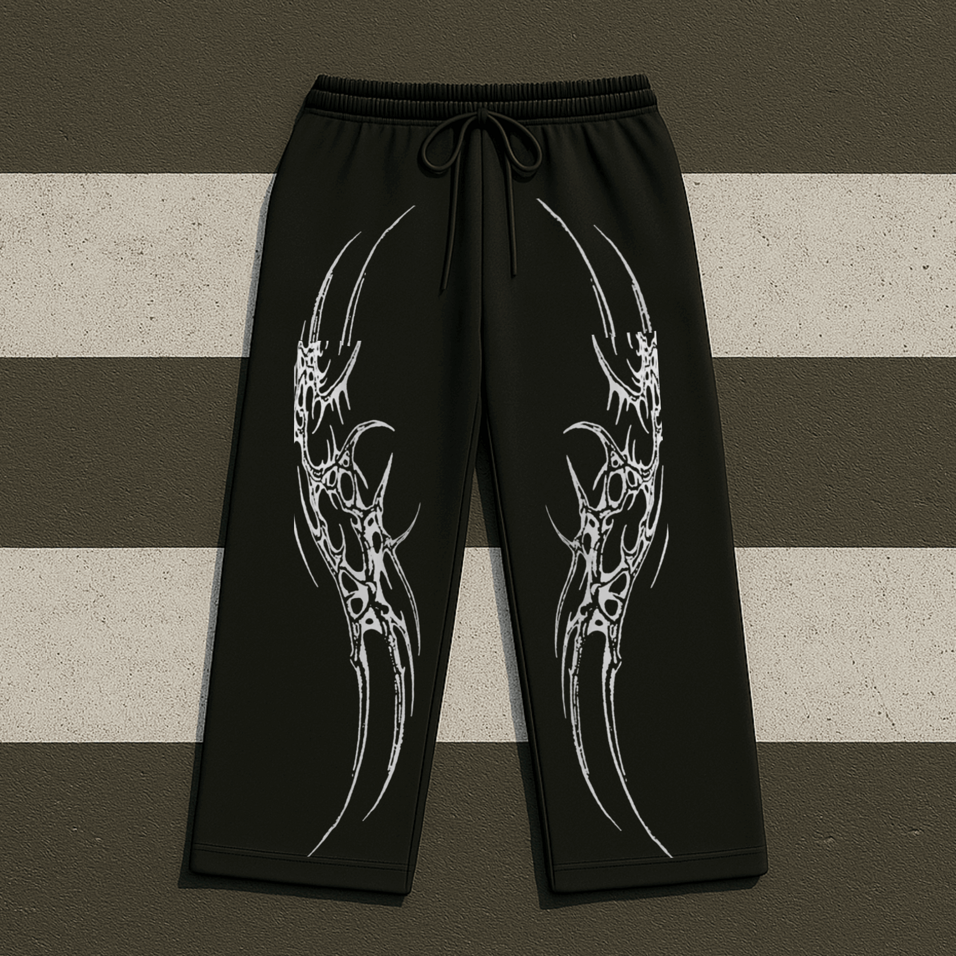 Black pants with white tribal designs on a striped background