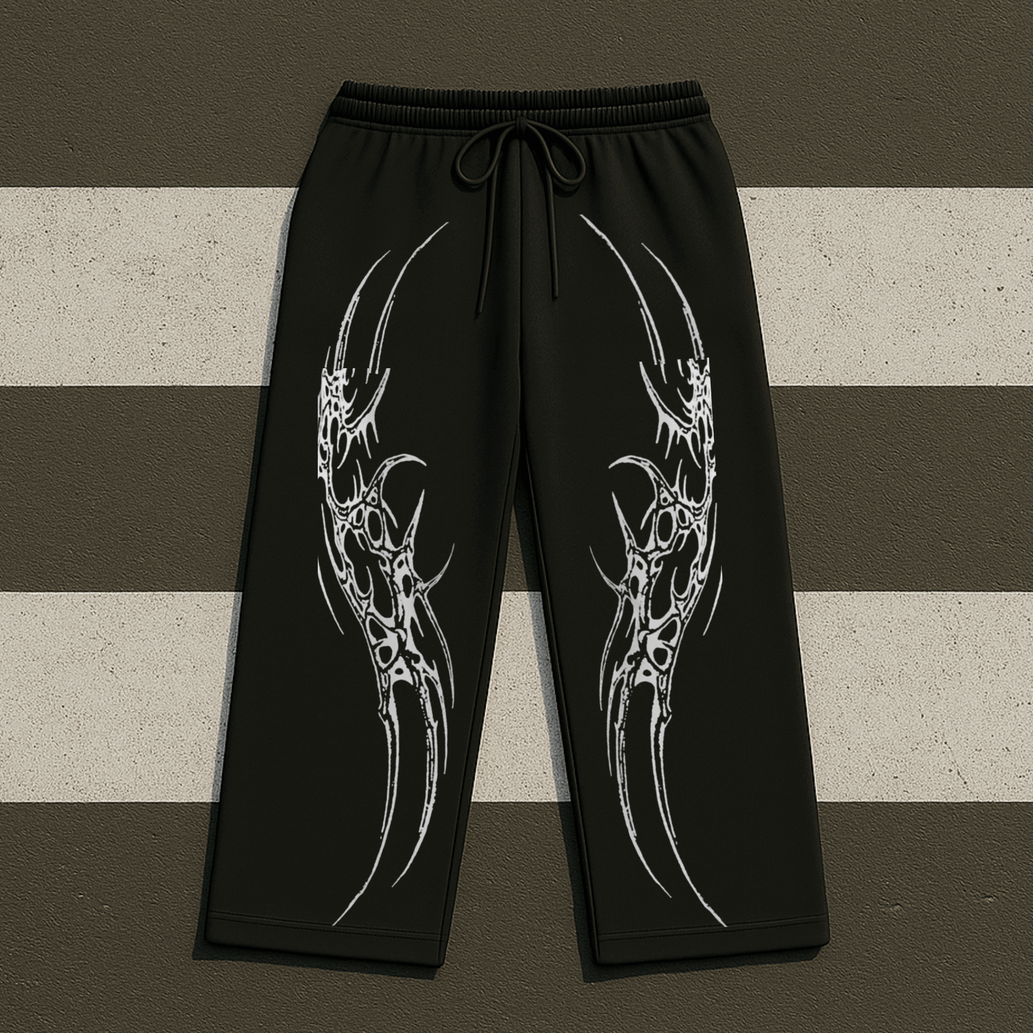 Black pants with white tribal designs on a striped background