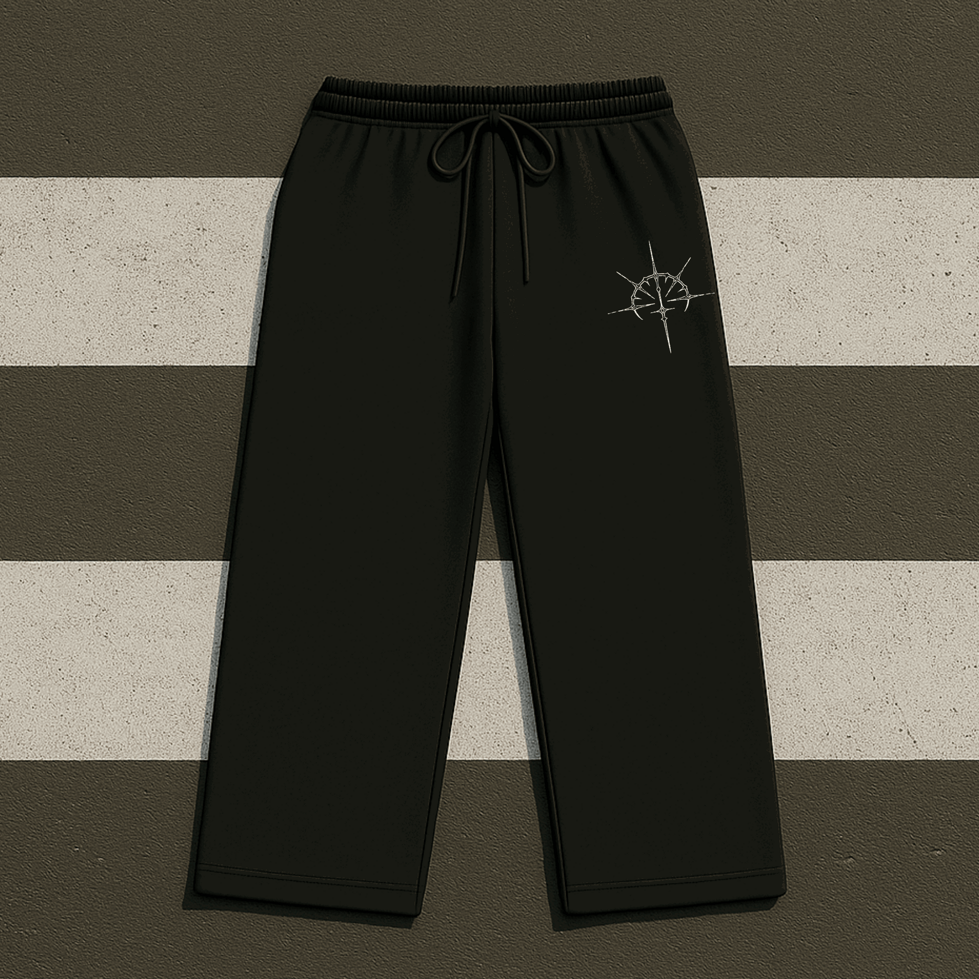 Black pants with a logo on a striped background