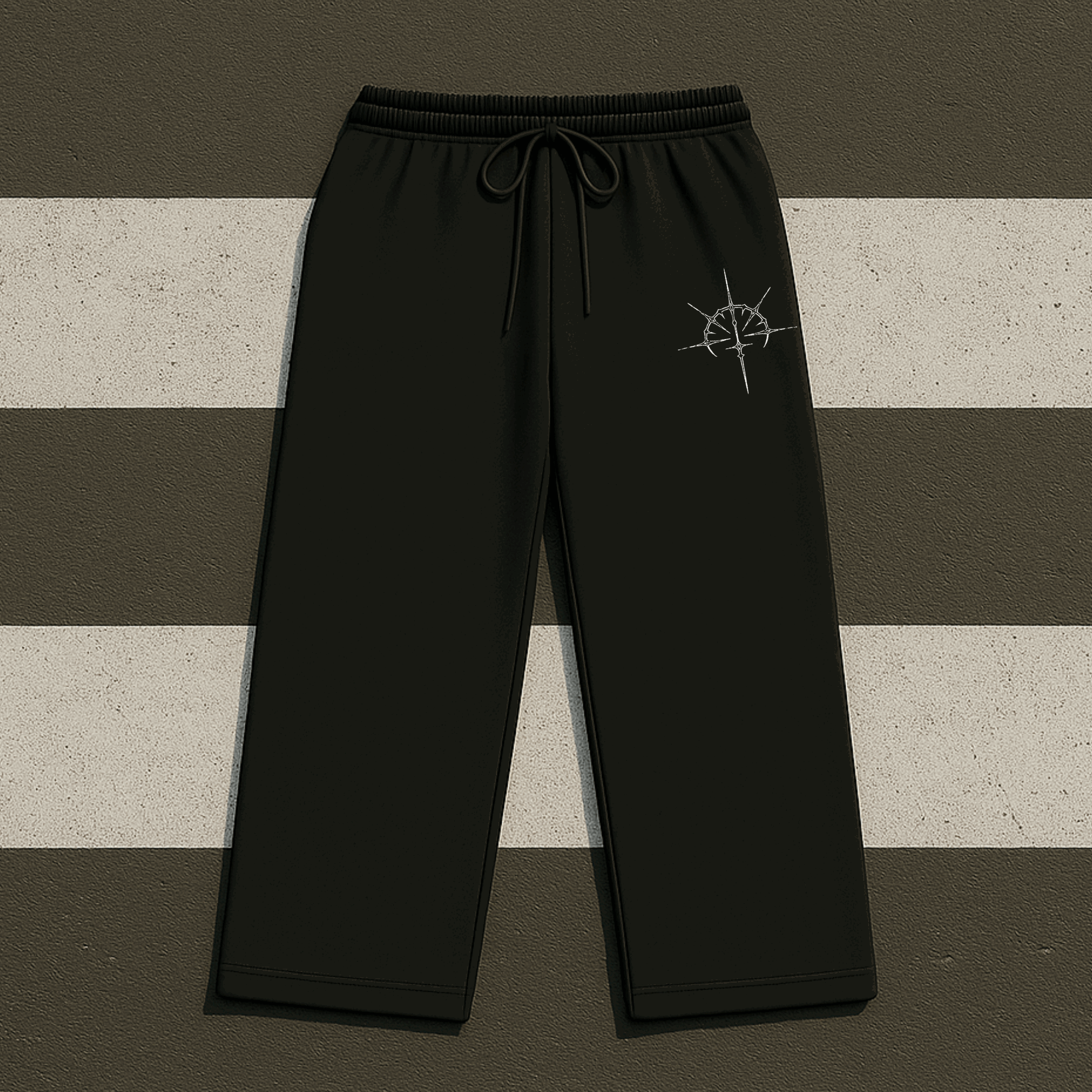 Black pants with a logo on a striped background