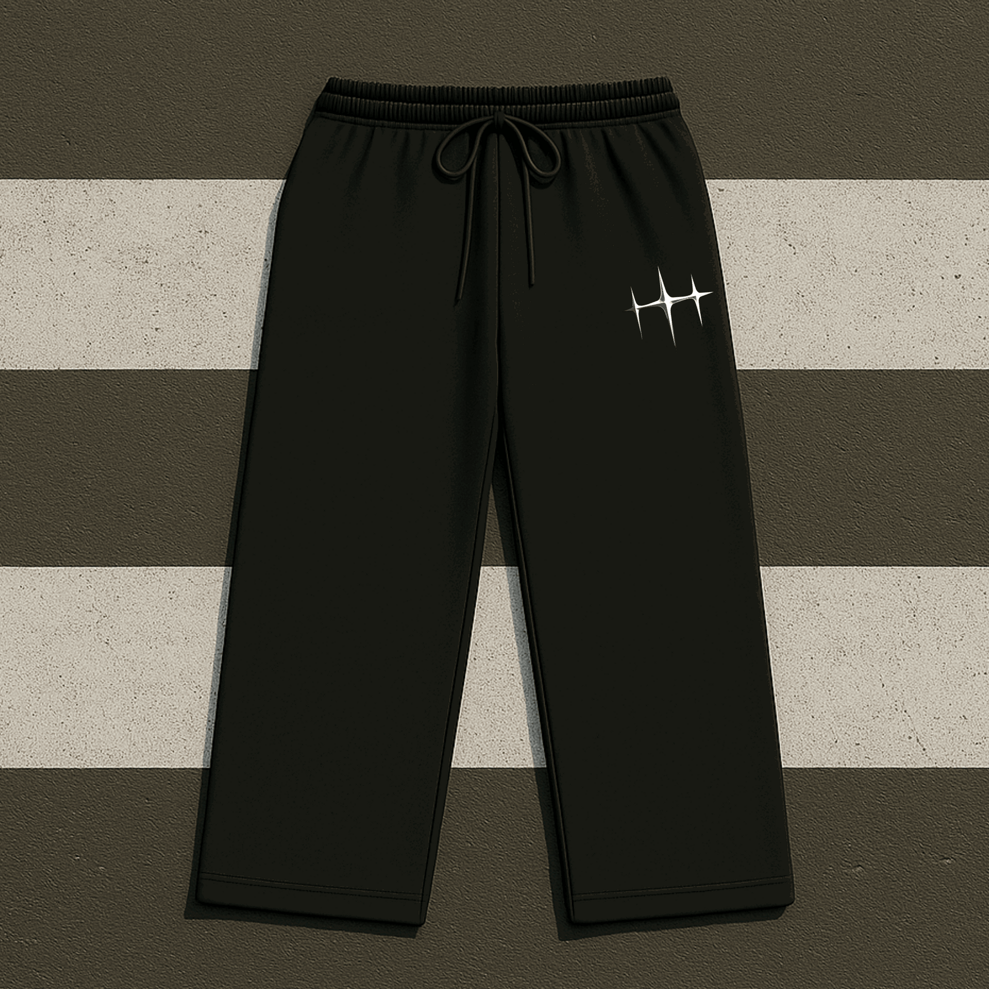 Black sweatpants with a logo on a striped background