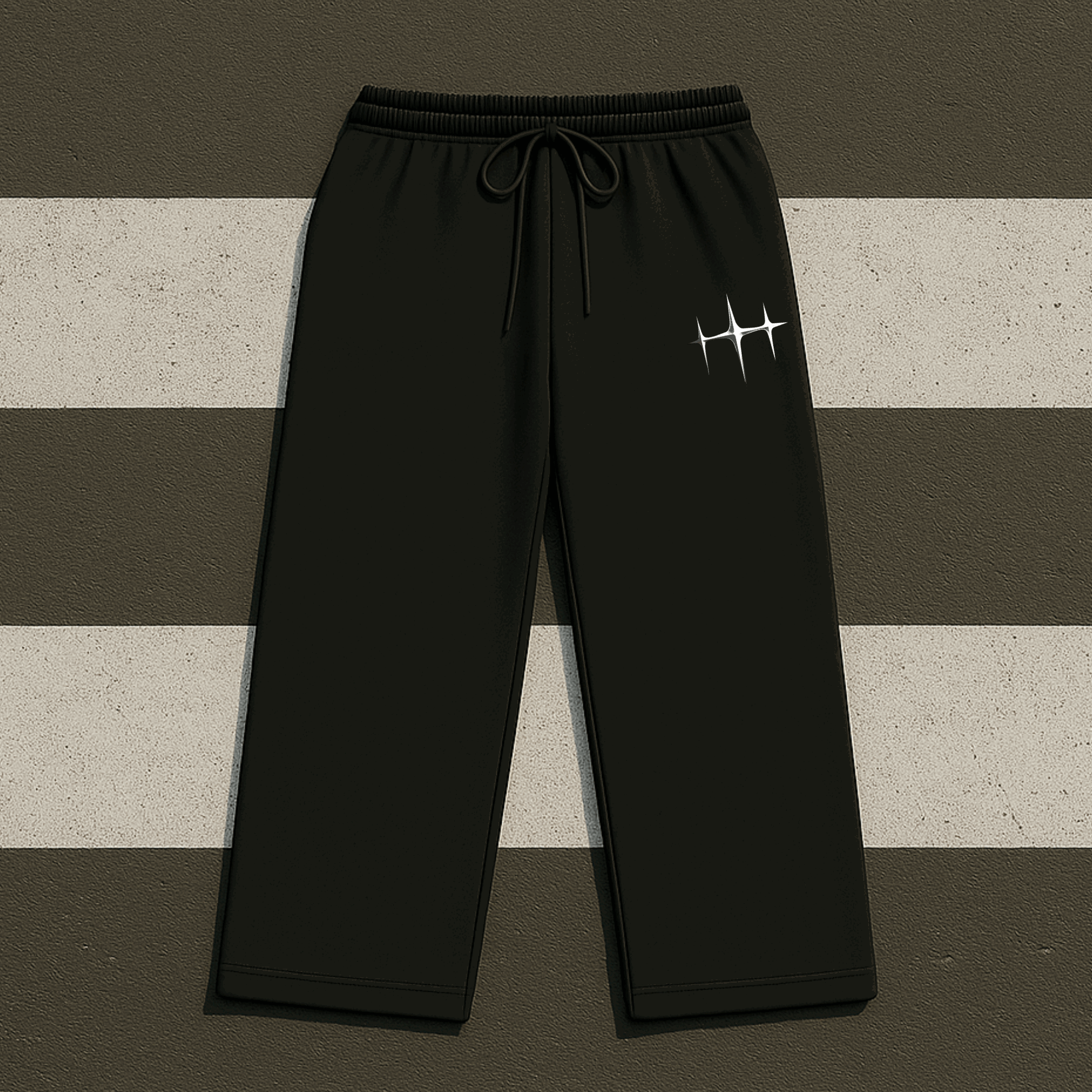 Black sweatpants with a logo on a striped background