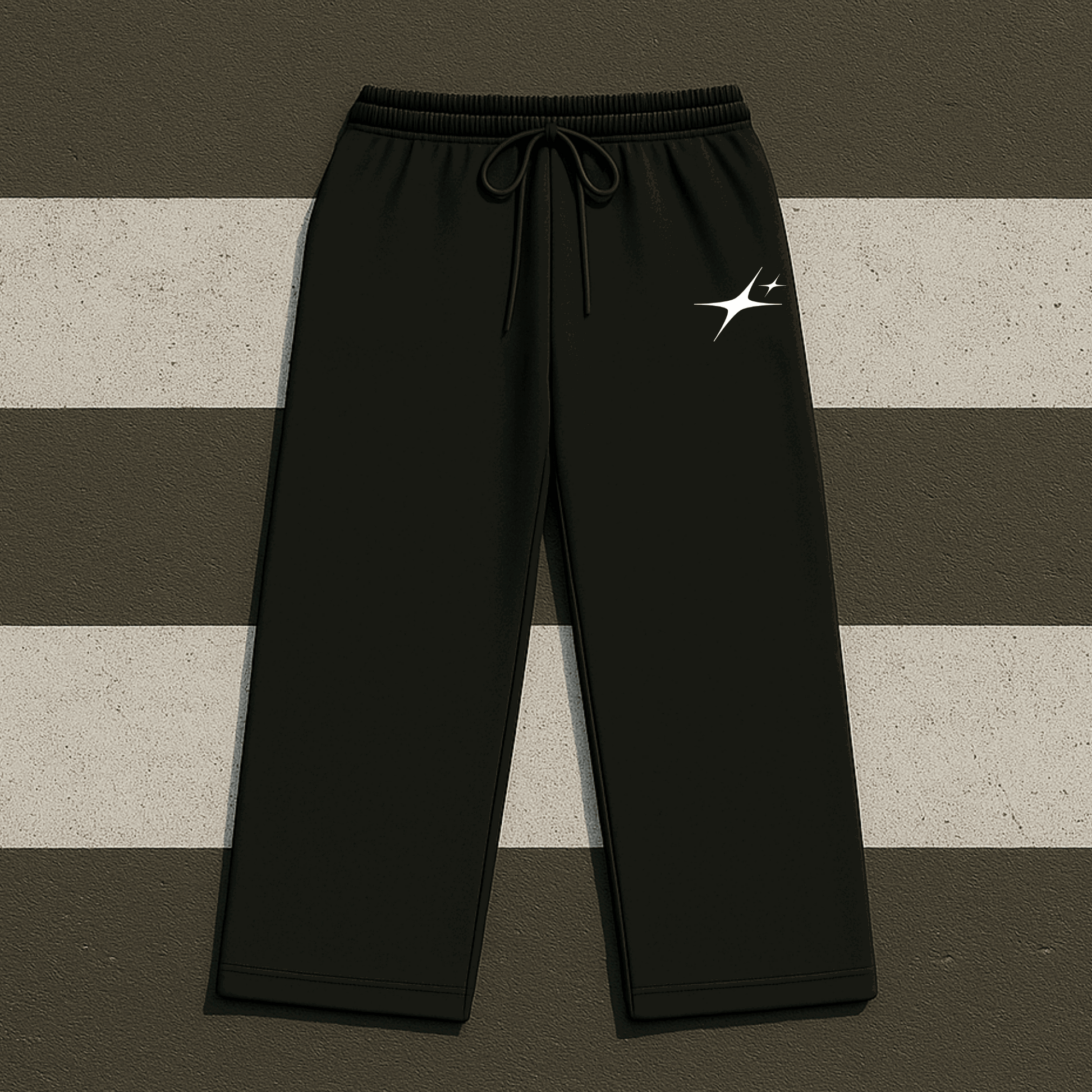 Black sweatpants with a logo on a striped background