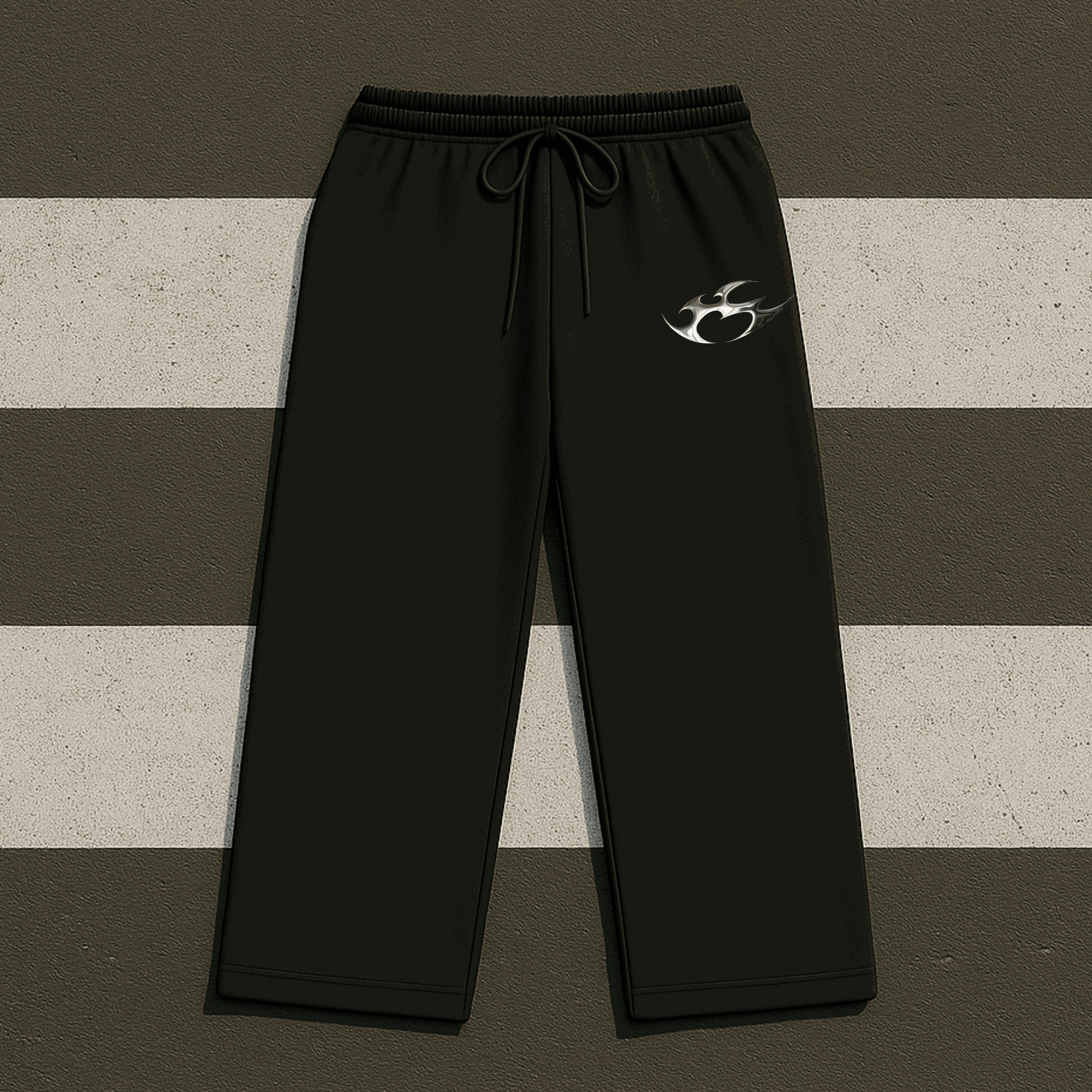 Black sweatpants with a logo on a striped background