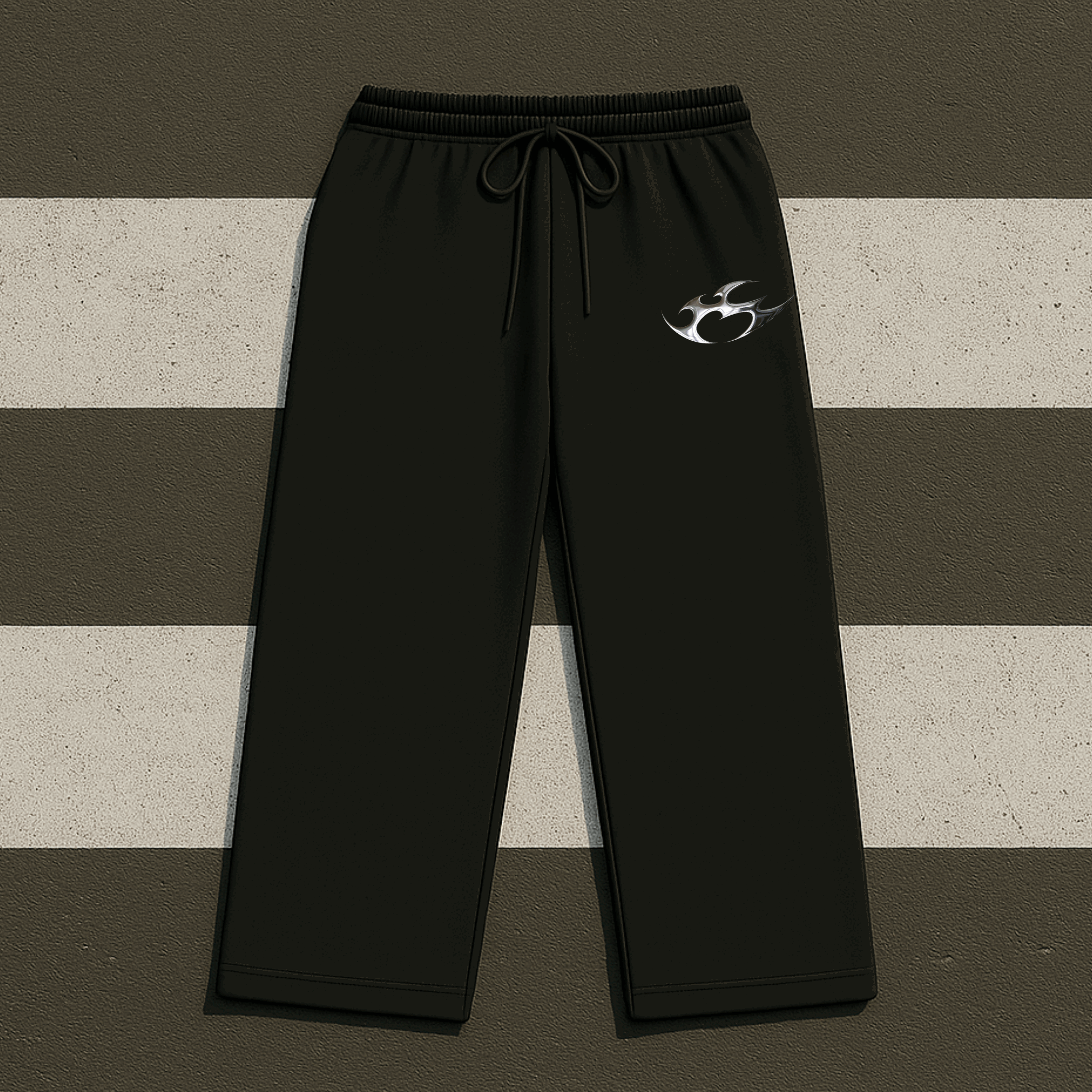 Black sweatpants with a logo on a striped background