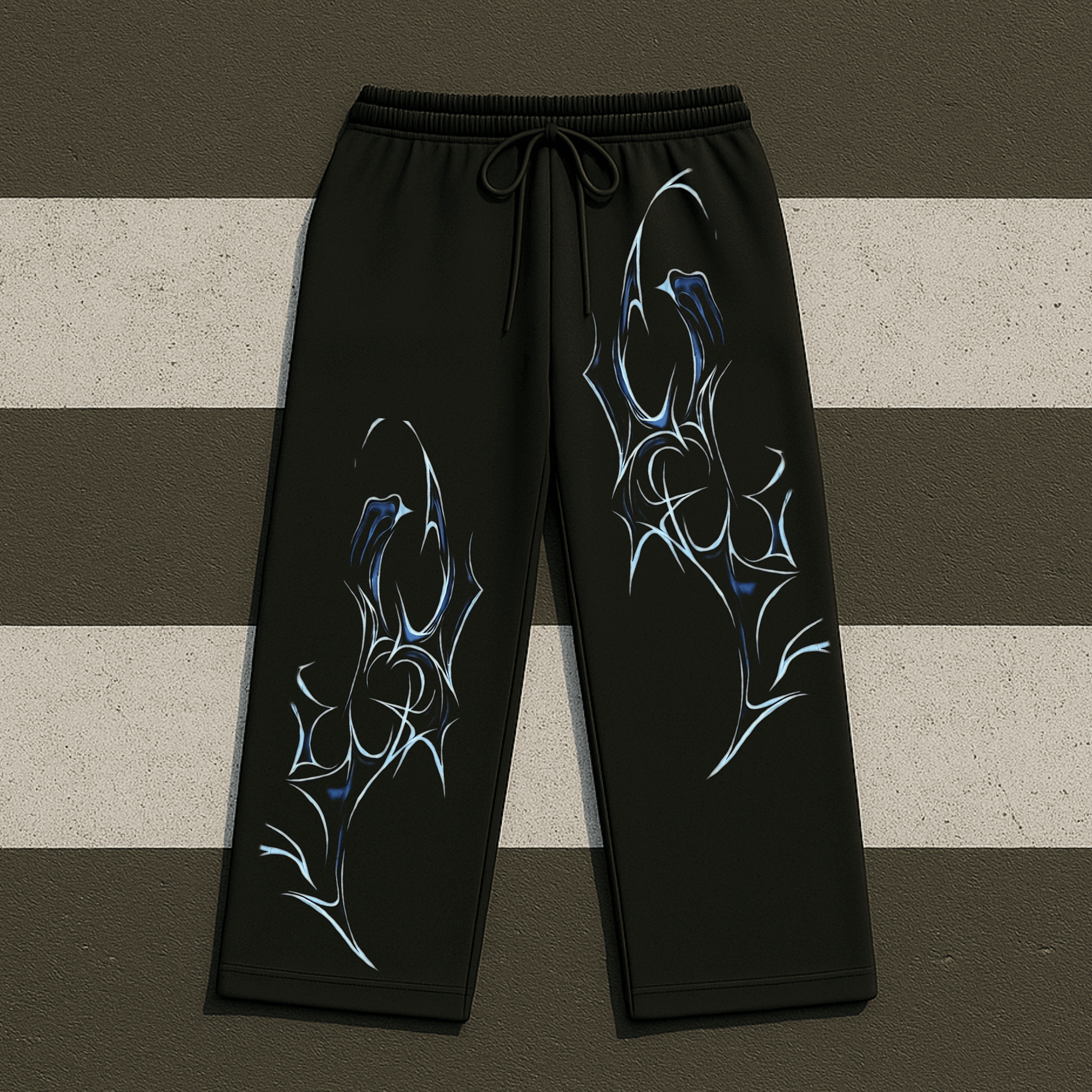 Black sweatpants with blue and white abstract designs on a striped background