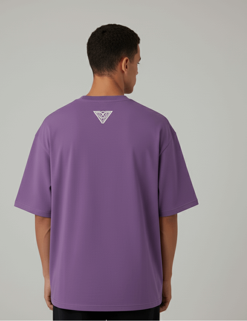 Person wearing a purple t-shirt with a logo on the back against a gray background